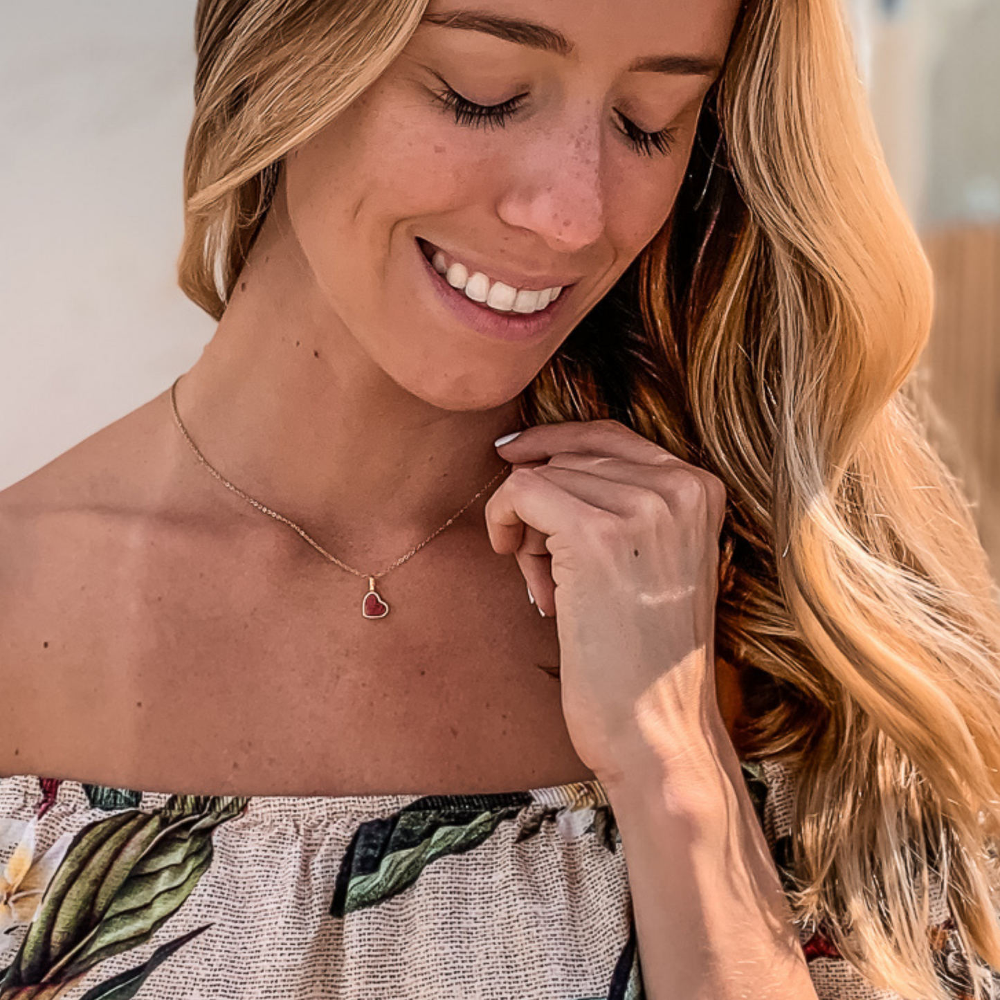 Yellow gold charm necklace with a heart shaped red feldspar natural gemstone. Made by Born to Rock. Online jewelry store based in San Diego California