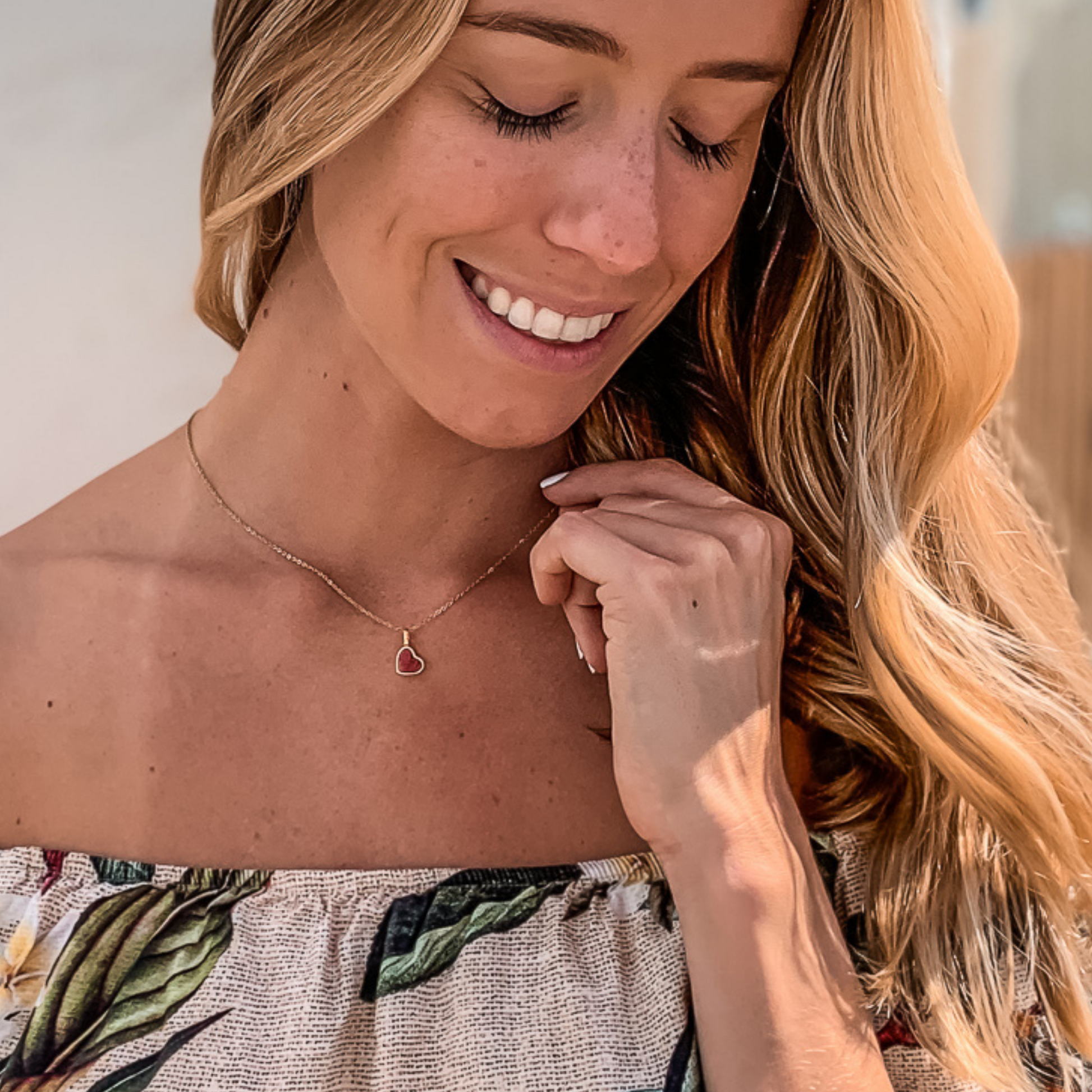 Yellow gold charm necklace with a heart shaped red feldspar natural gemstone. Made by Born to Rock. Online  jewelry store based in San Diego California