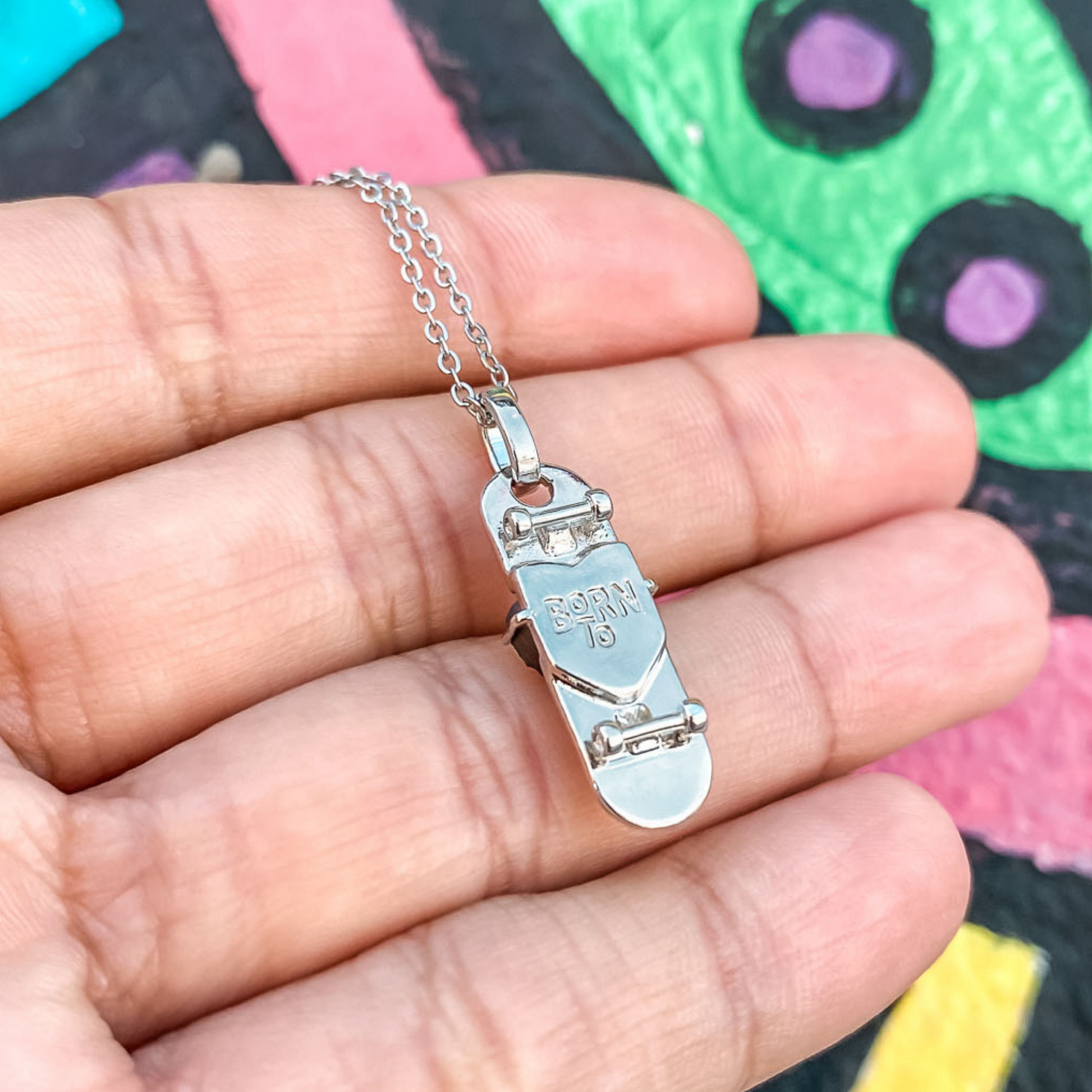silver plated skateboard charm necklace with a multicolor crystal druzy by born to rock jewelry