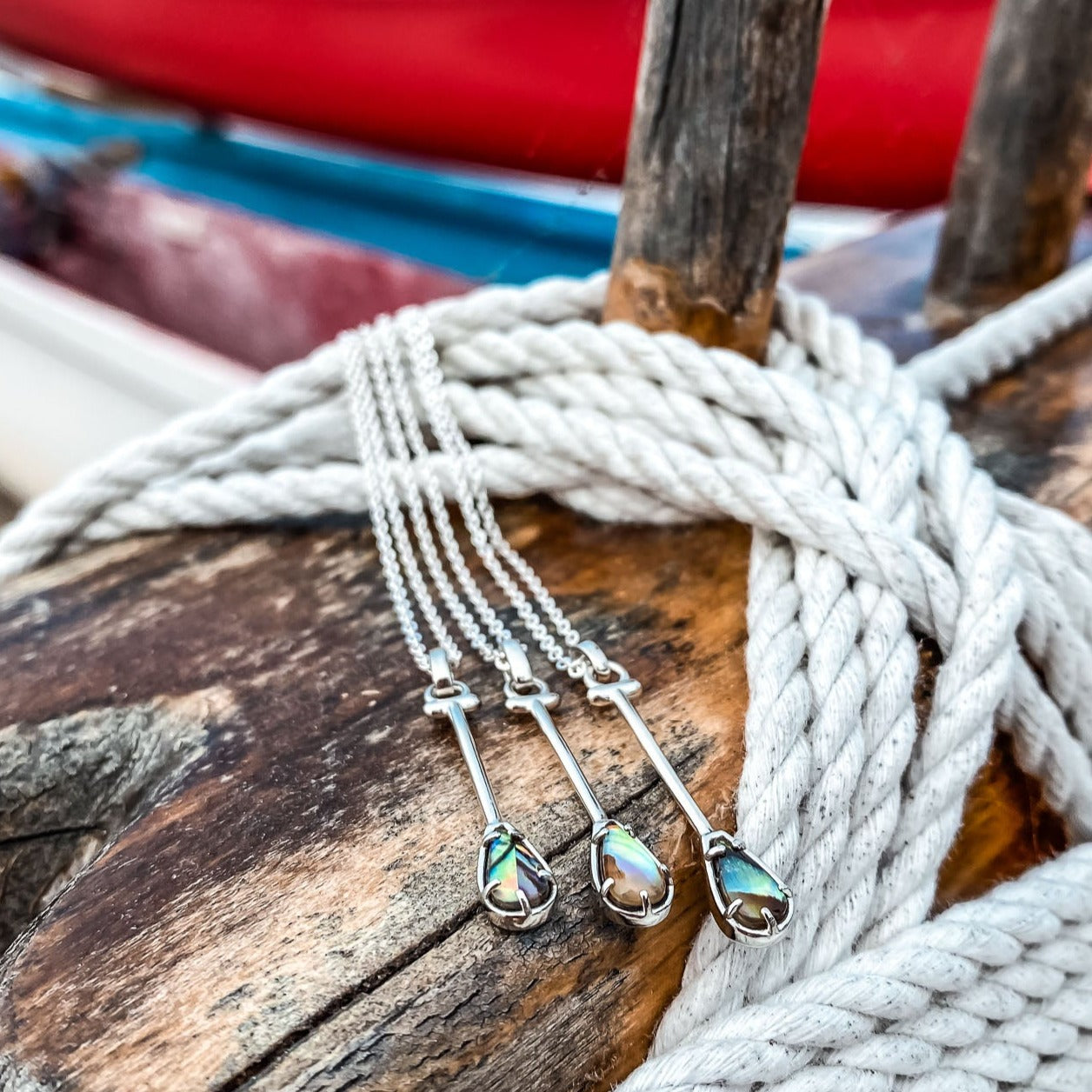 Sterling Silver Hawaiian Outrigger Canoe Paddle Charm Necklace in Abalone Shell Natural Gemstone. Made by Born to Rock Jewelry Store based in San Diego California. Paddling jewelry