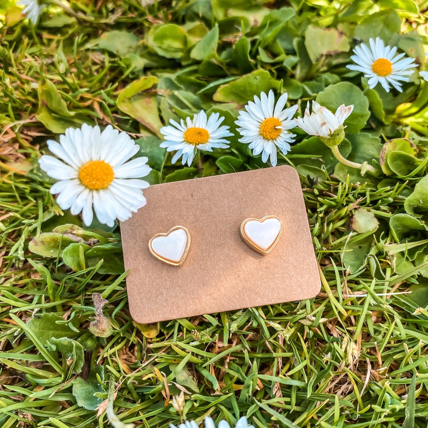 Yellow Gold plated earrings with a heart shaped mother-of-pearl pendant. Wedding and bridal jewelry. Great gift fro brides, bridesmaid and maid of honor made by Born to Rock . Jewelry store based in San Diego California