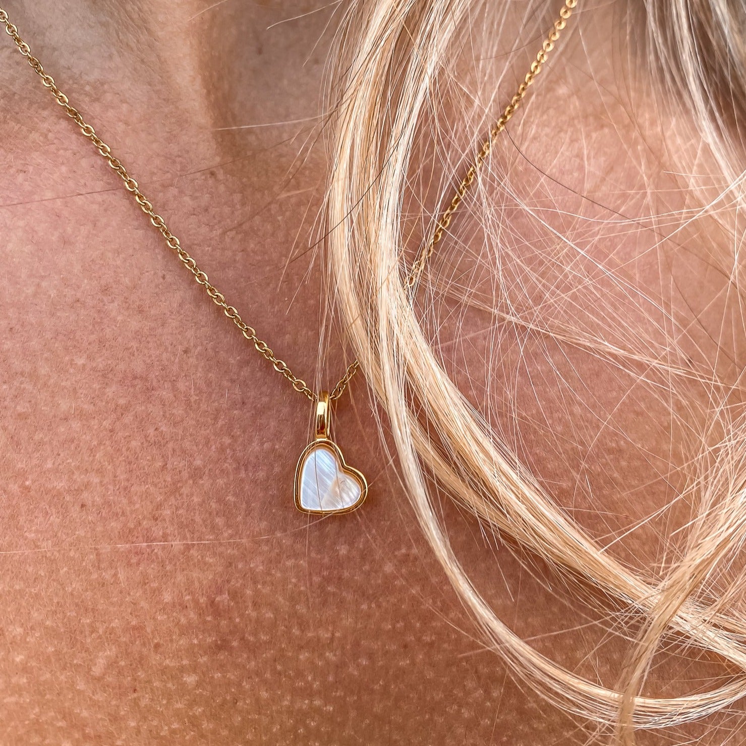 Yellow Gold plated charm necklace with a heart shaped mother-of-pearl pendant. Wedding and bridal jewelry. Great gift fro brides, bridesmaid and maid of honor made by Born to Rock . Jewelry store based in San Diego California