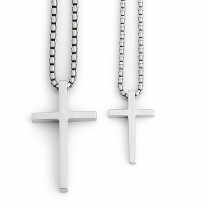 Two silver cross necklaces on white background