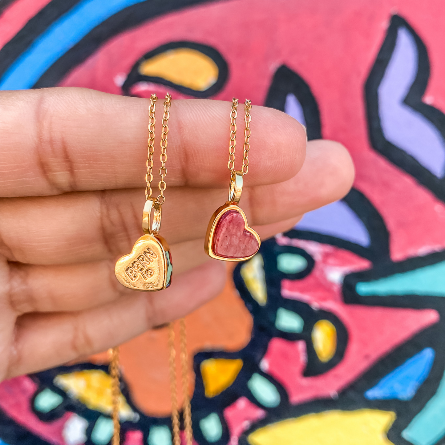 Yellow gold charm necklace with a heart shaped red feldspar natural gemstone. Made by Born to Rock. Online  jewelry store based in San Diego California