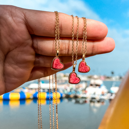 Yellow gold charm necklace with a heart shaped red feldspar natural gemstone. Made by Born to Rock. Online  jewelry store based in San Diego California