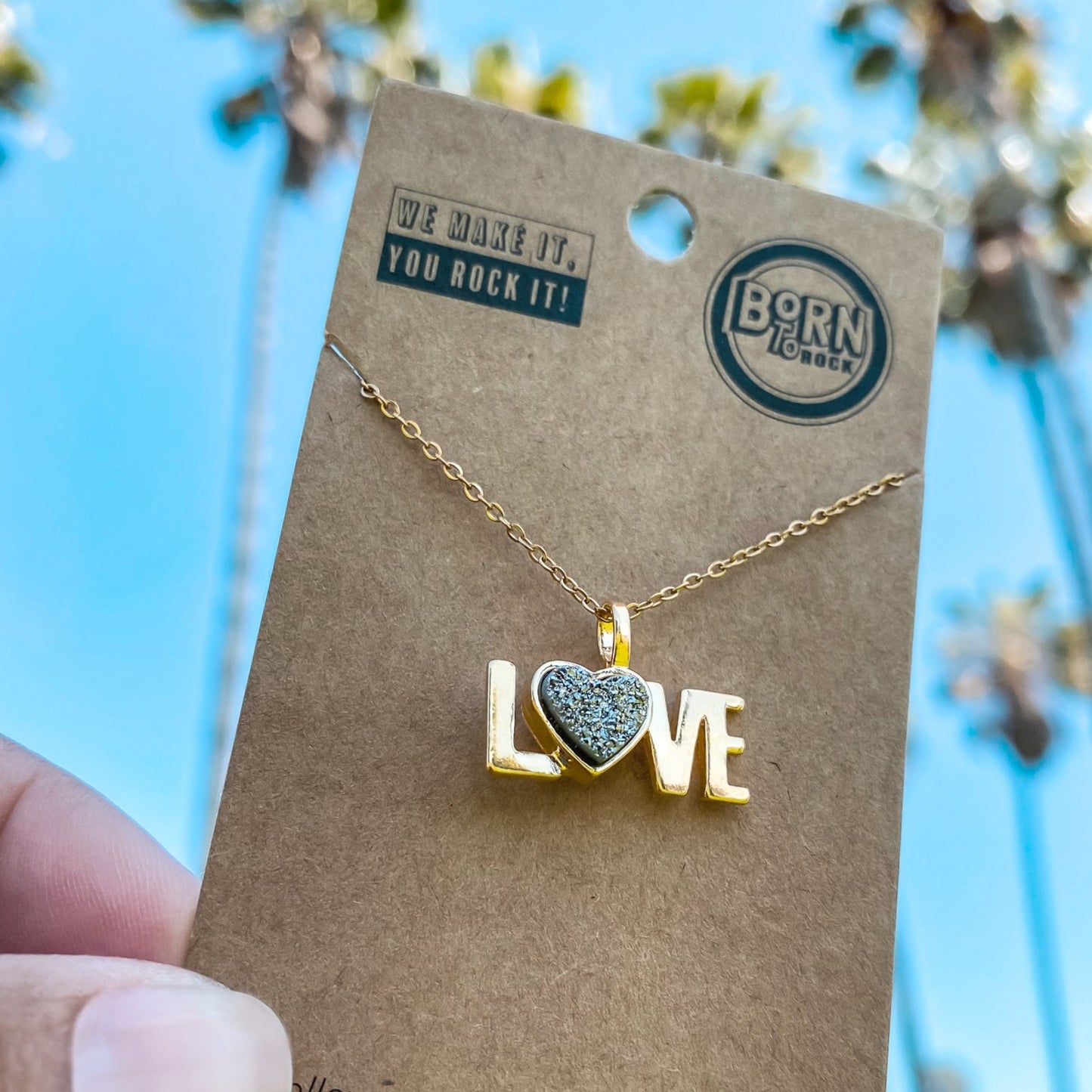 18kt Yellow Gold Love word charm necklace with a heart shaped natural Quartz Druzy Crystal made by Born to Rock. Online Jewelry store based in San Diego California