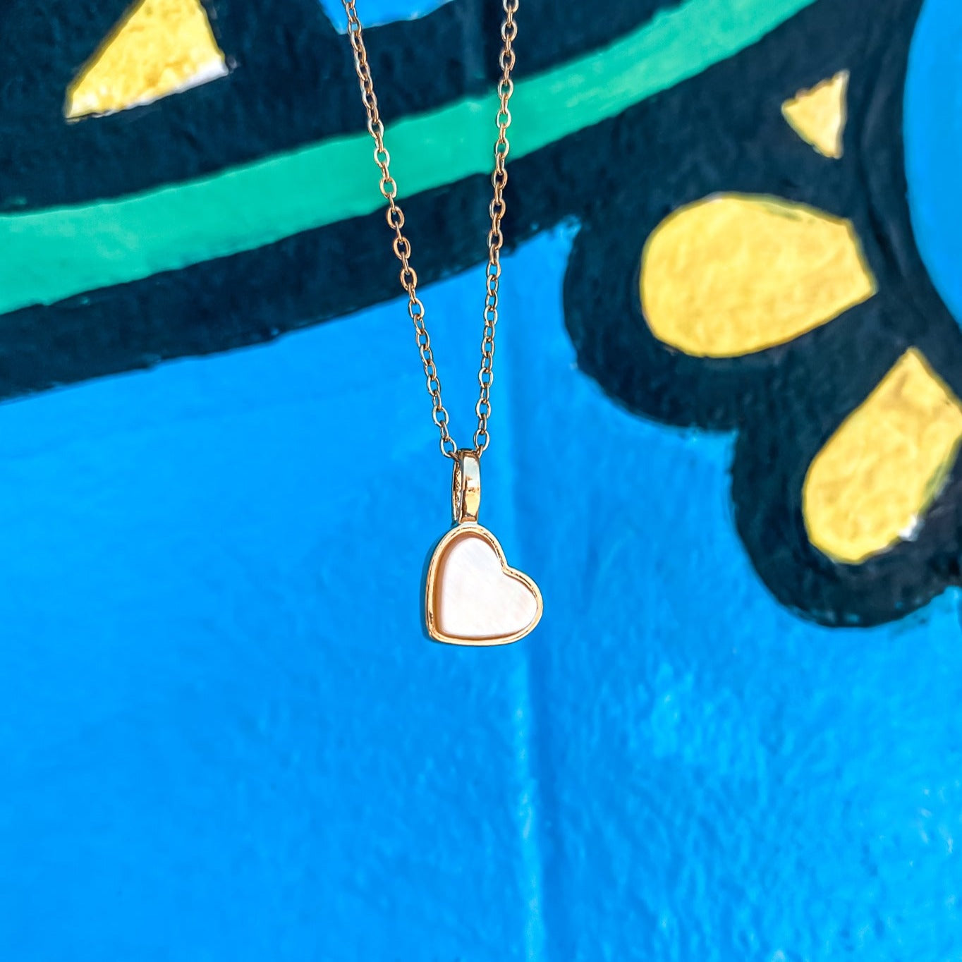 Yellow Gold plated charm necklace with a heart shaped mother-of-pearl pendant. Wedding and bridal jewelry. Great gift fro brides, bridesmaid and maid of honor made by Born to Rock . Jewelry store based in San Diego California