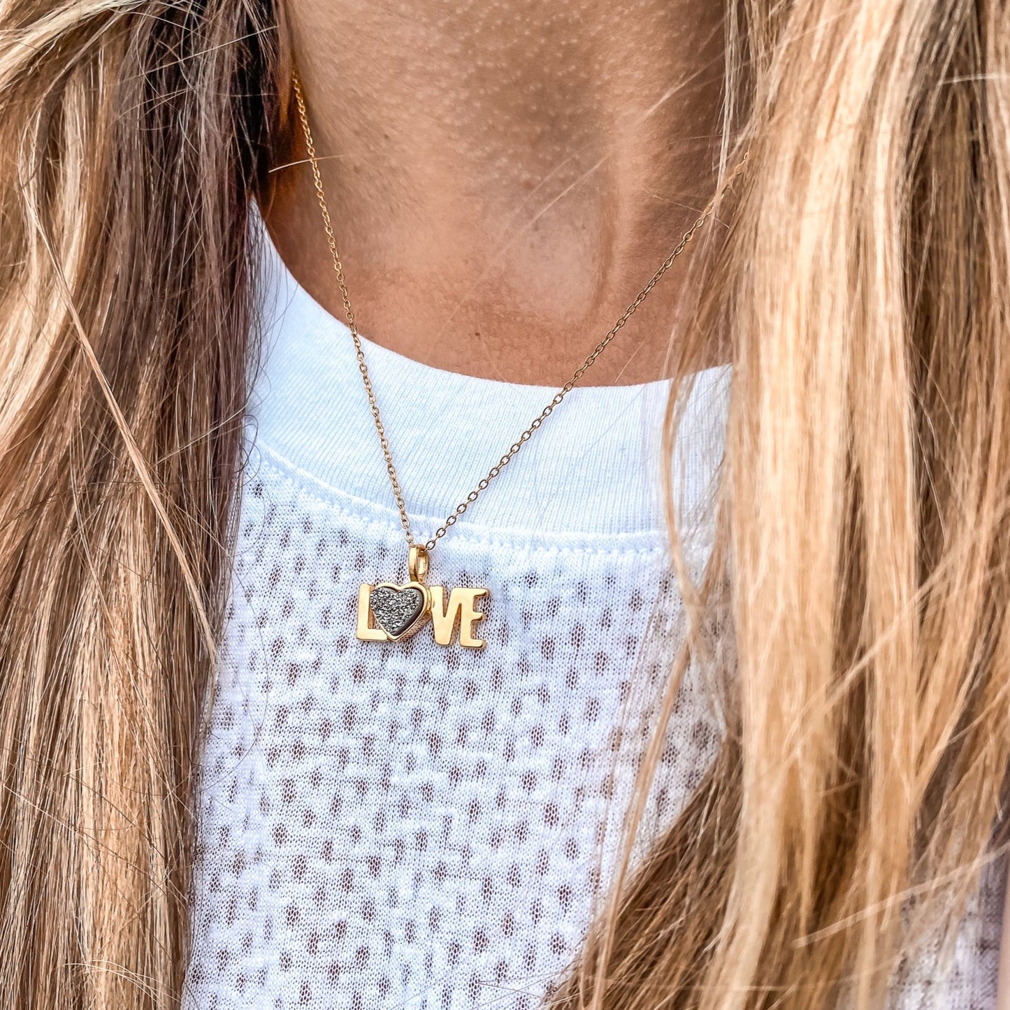 18kt Yellow Gold Love word charm necklace with a heart shaped natural Quartz Druzy Crystal made by Born to Rock. Online Jewelry store based in San Diego California