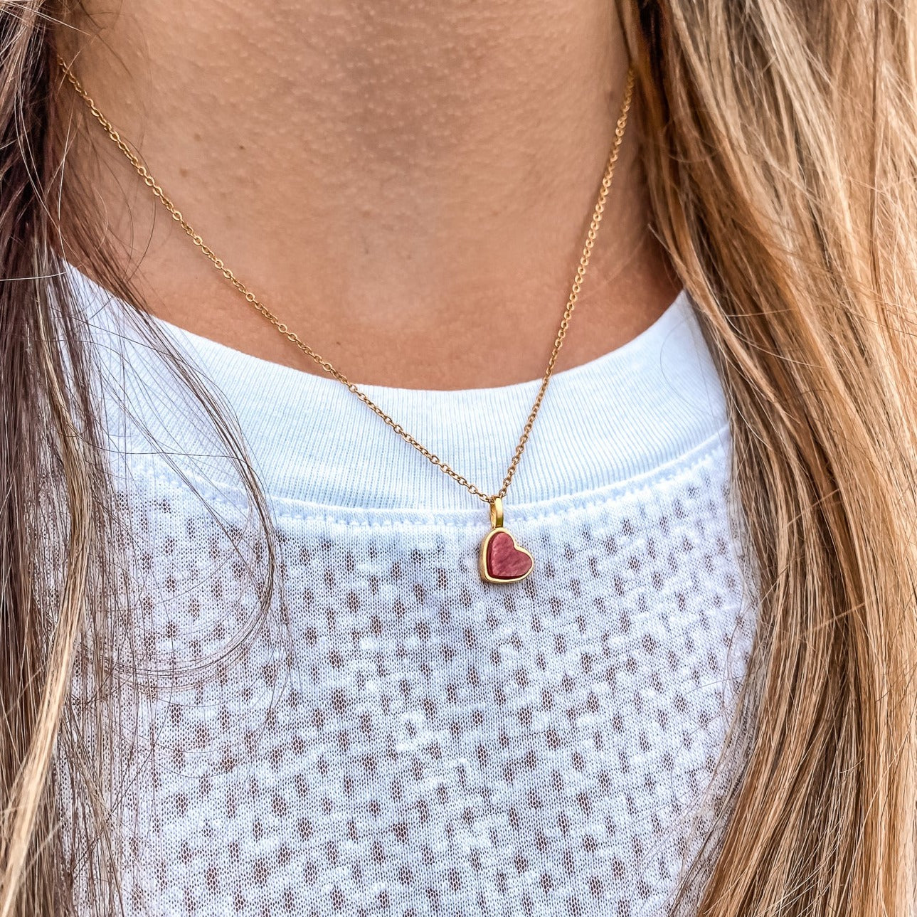 Yellow gold charm necklace with a heart shaped red feldspar natural gemstone. Made by Born to Rock. Online  jewelry store based in San Diego California