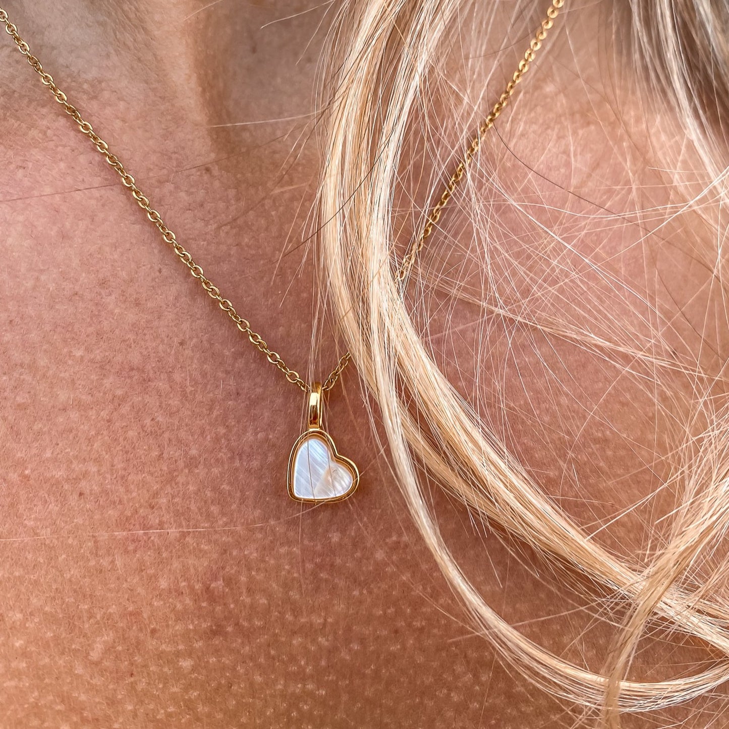 Yellow Gold plated charm necklace with a heart shaped mother-of-pearl pendant. Wedding and bridal jewelry. Great gift fro brides, bridesmaid and maid of honor made by Born to Rock . Jewelry store based in San Diego California