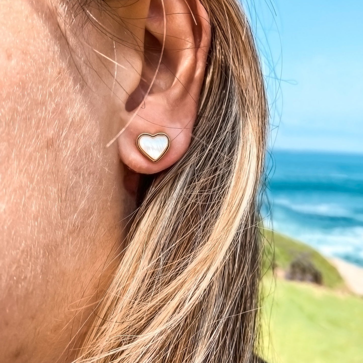 Yellow Gold plated earrings with a heart shaped mother-of-pearl pendant. Wedding and bridal jewelry. Great gift fro brides, bridesmaid and maid of honor made by Born to Rock . Jewelry store based in San Diego California