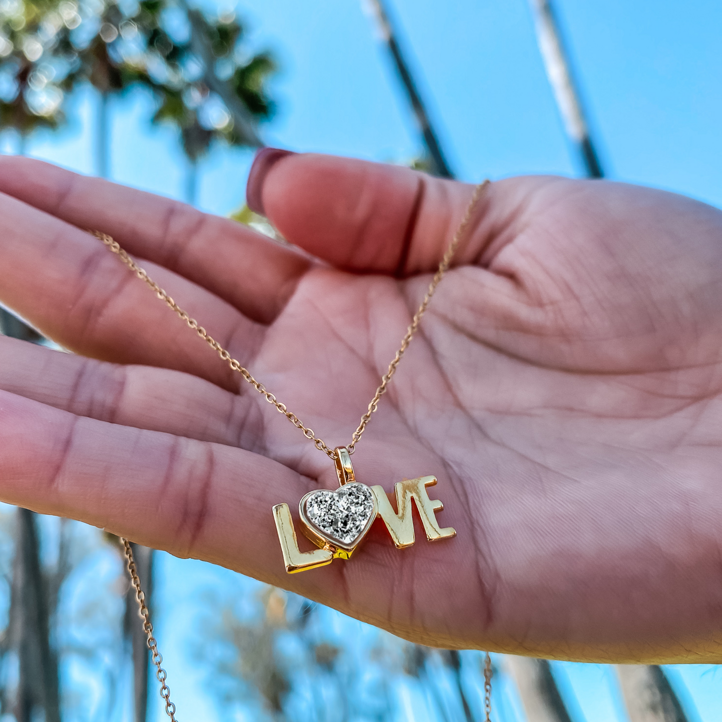 18kt Yellow Gold Love word charm necklace with a heart shaped natural Quartz Druzy Crystal made by Born to Rock. Online Jewelry store based in San Diego California